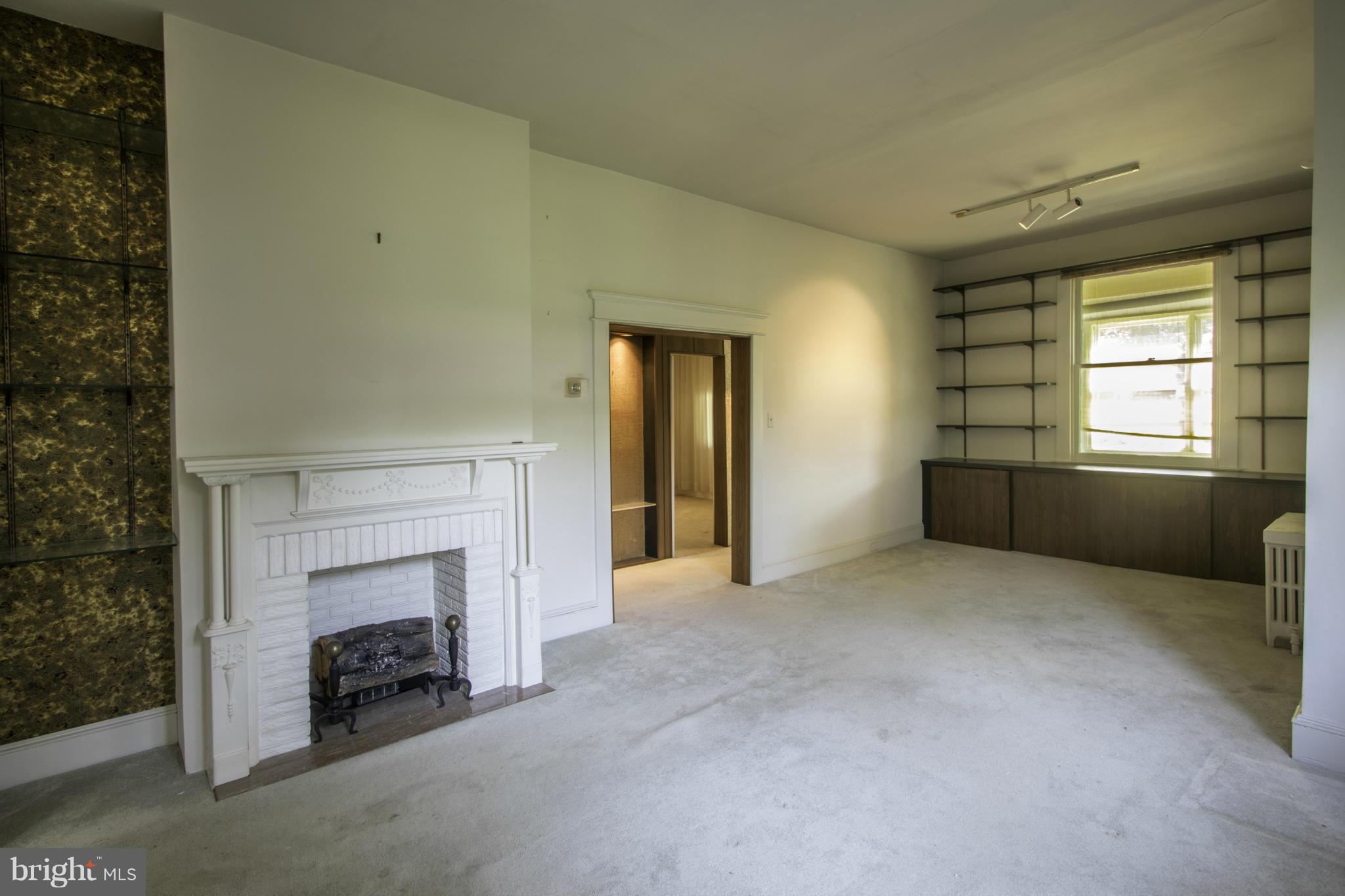 112 North Hammonds Ferry Road Linthicum Heights, MD 21090 - Photo 12 of 30 an empty room with windows and fireplace