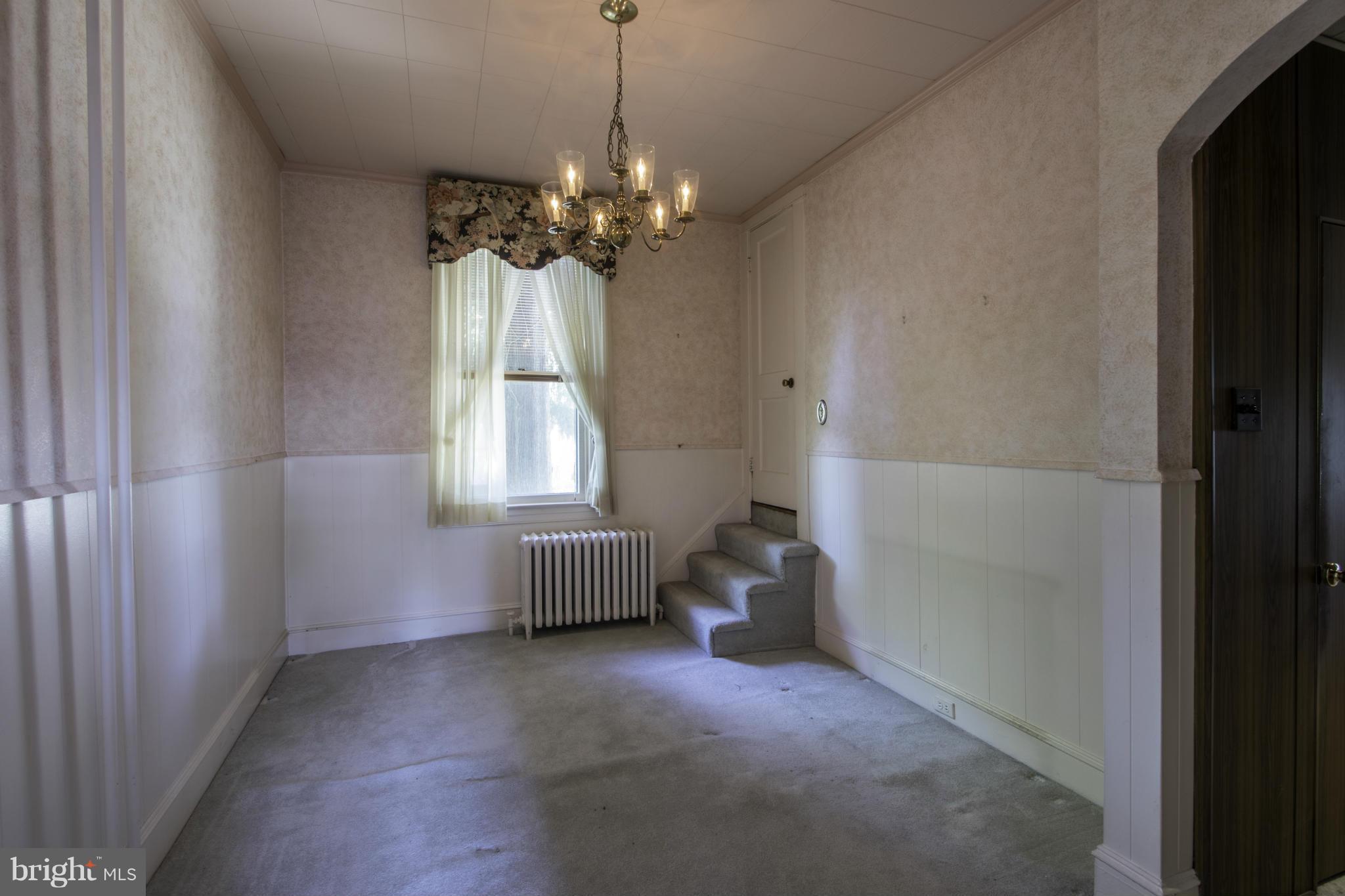 112 North Hammonds Ferry Road Linthicum Heights, MD 21090 - Photo 14 of 30 a living room with windows and a chandelier