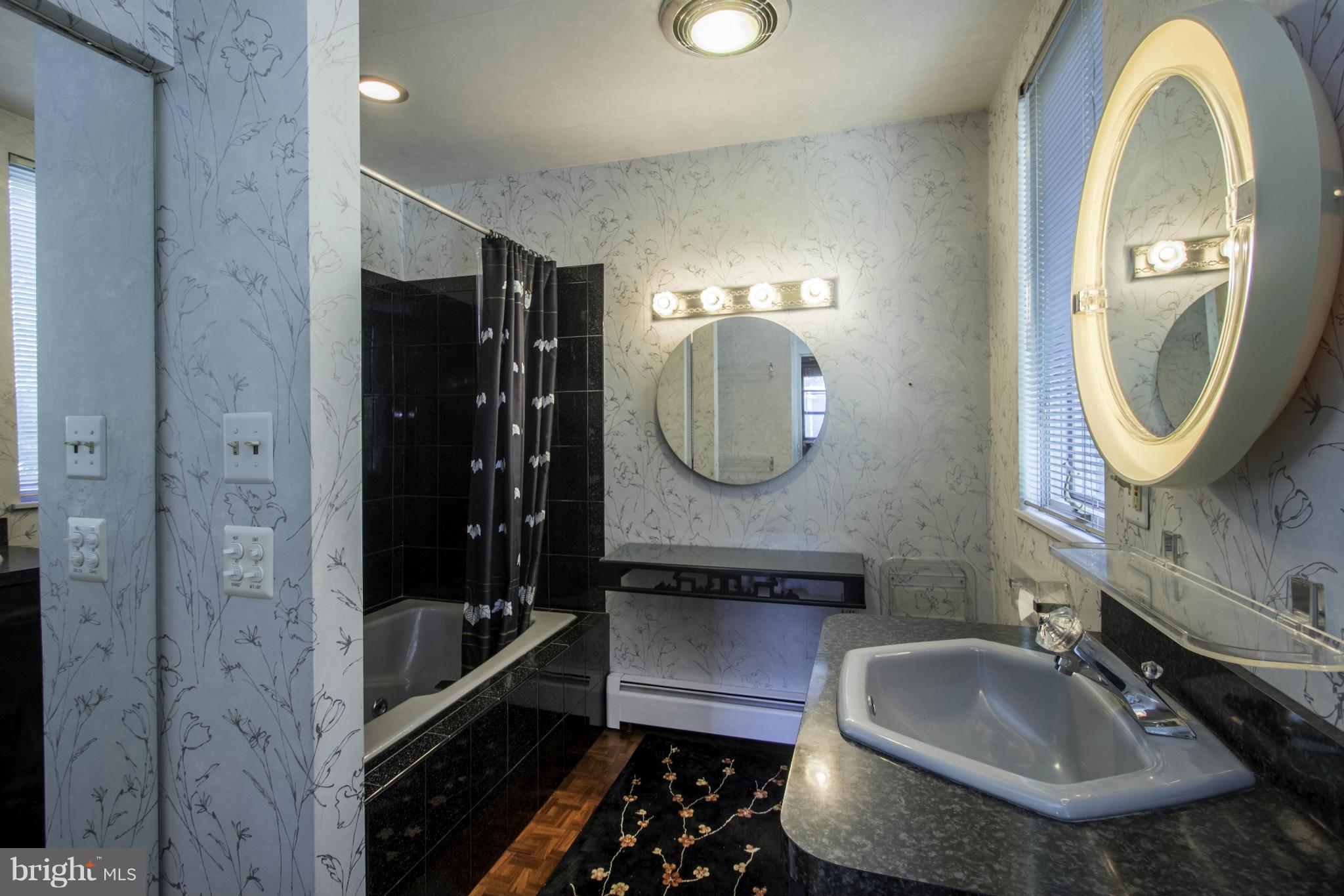 112 North Hammonds Ferry Road Linthicum Heights, MD 21090 - Photo 23 of 30 a bathroom with a sink and a mirror