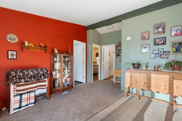 a bedroom with a bed and a chair