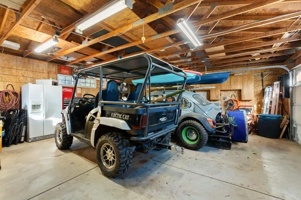 a front view of house with yard and trees in the background