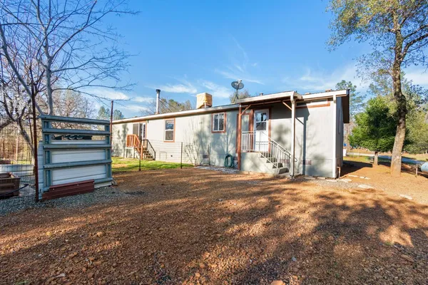 a view of a roof deck with table and chairs under an umbrella