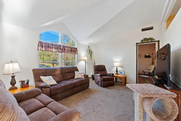 a living room with furniture a lamp and a window