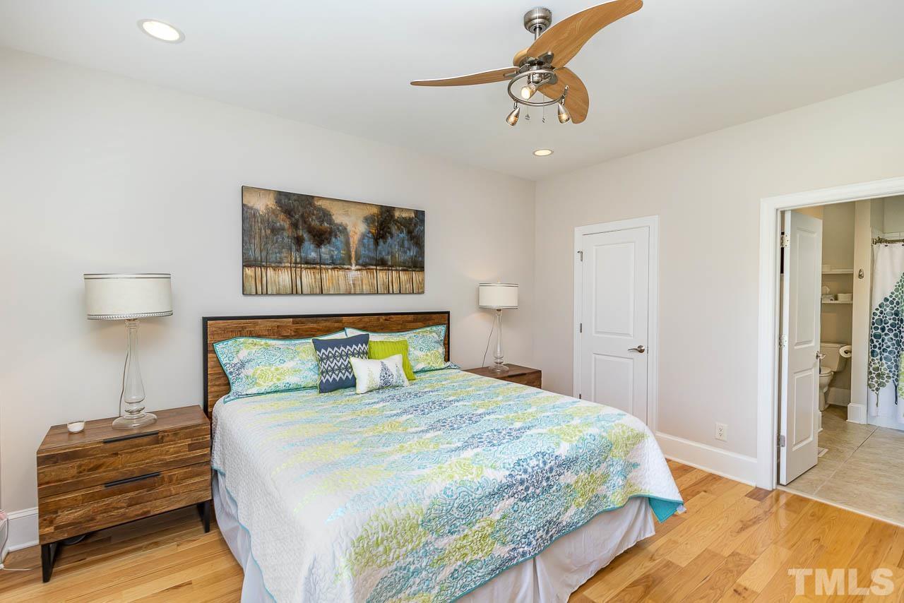 412 Deep Woods Trail Wake Forest, NC 27587 - Photo 23 of 35 a bedroom with a bed and wooden floor