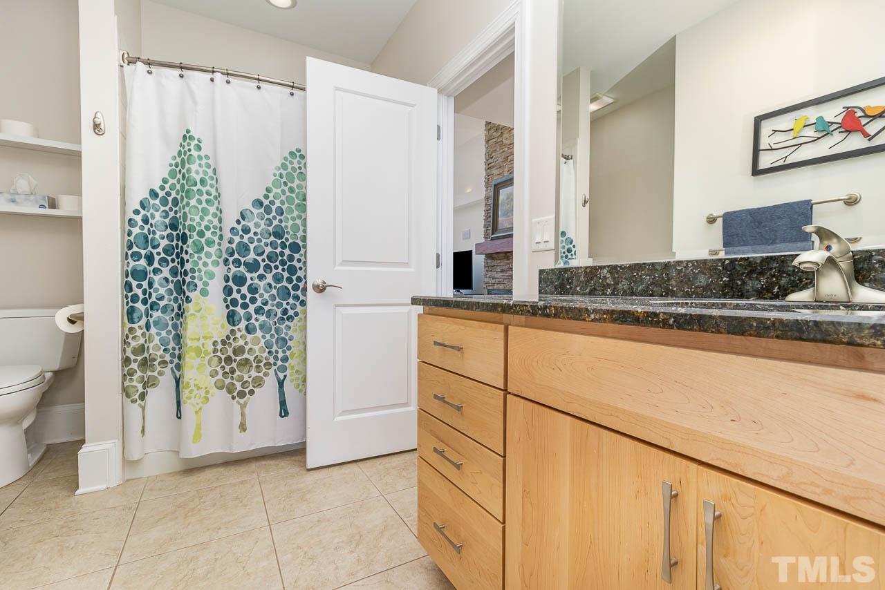 412 Deep Woods Trail Wake Forest, NC 27587 - Photo 24 of 35 a bathroom with a granite countertop sink a toilet and a shower