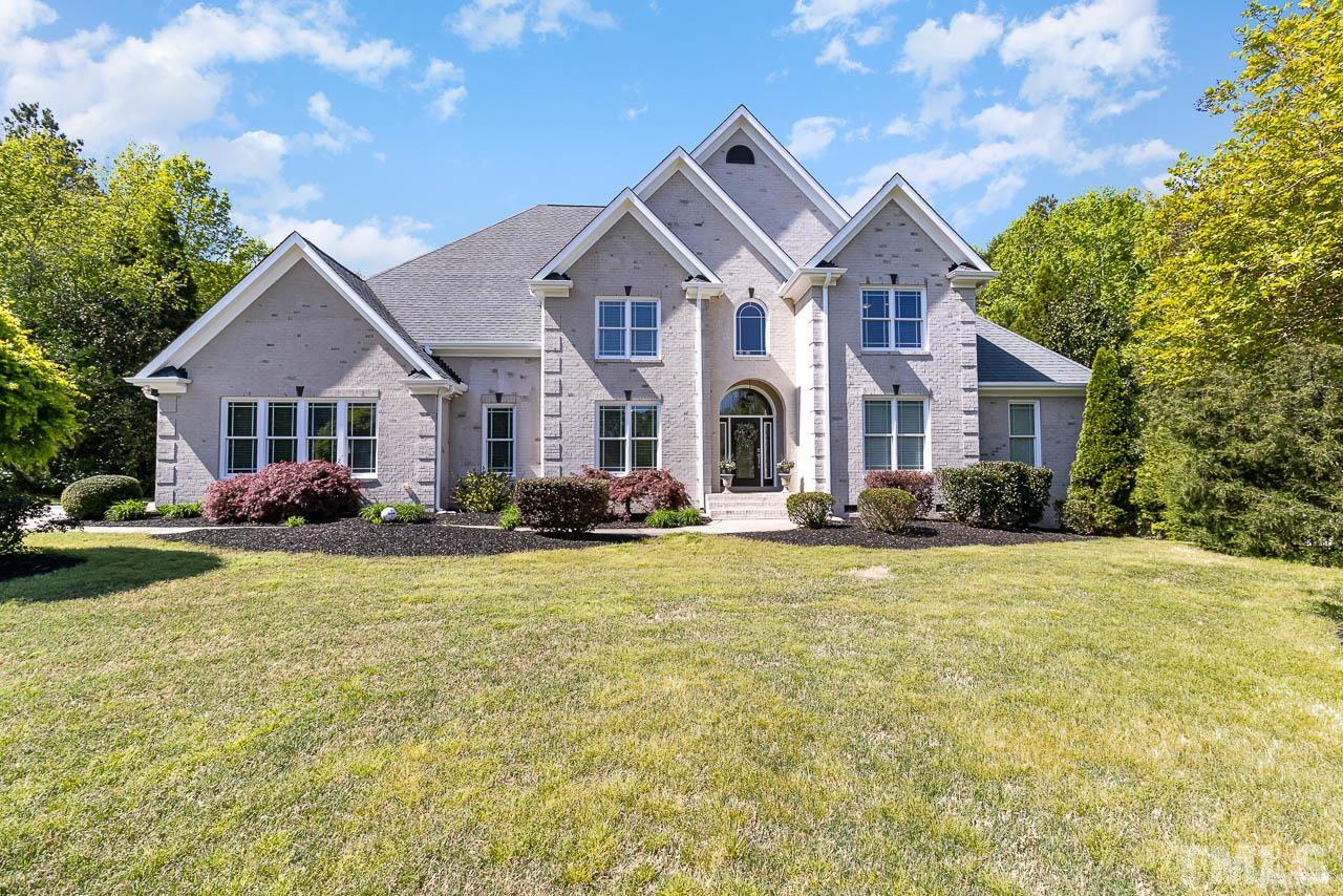 412 Deep Woods Trail Wake Forest, NC 27587 - Photo 5 of 35 a front view of a house with yard and green space