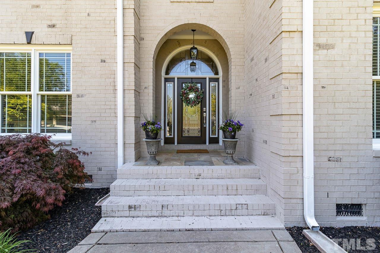 412 Deep Woods Trail Wake Forest, NC 27587 - Photo 8 of 35 a front view of a house with a garden