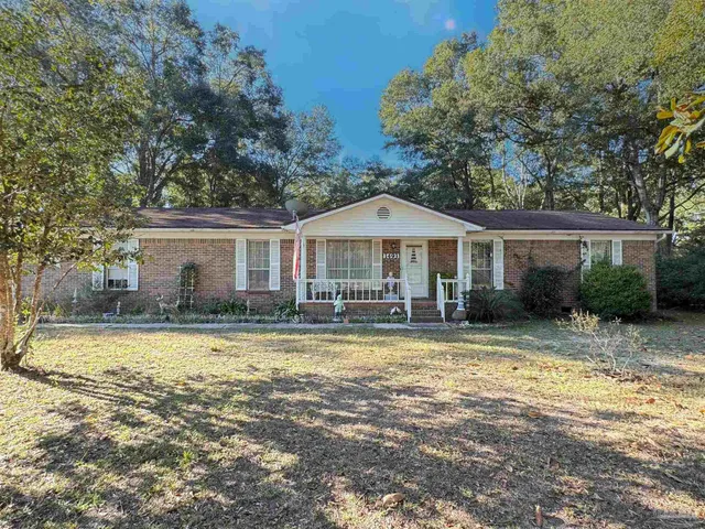 a view of a house with swimming pool and a yard