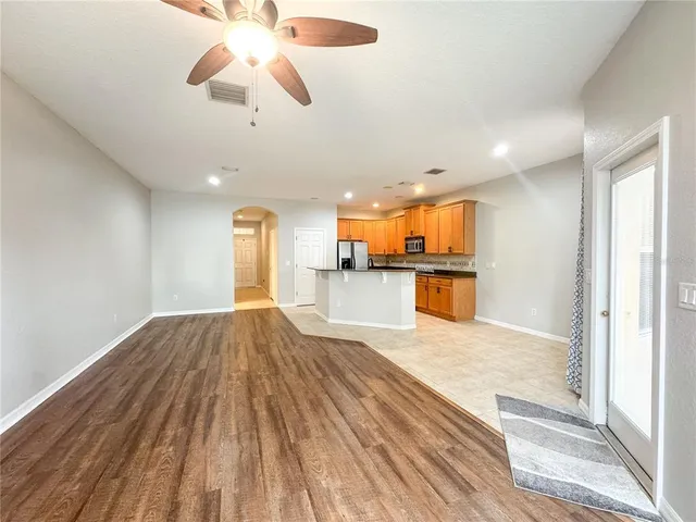 a view of a kitchen with a sink and wooden floor