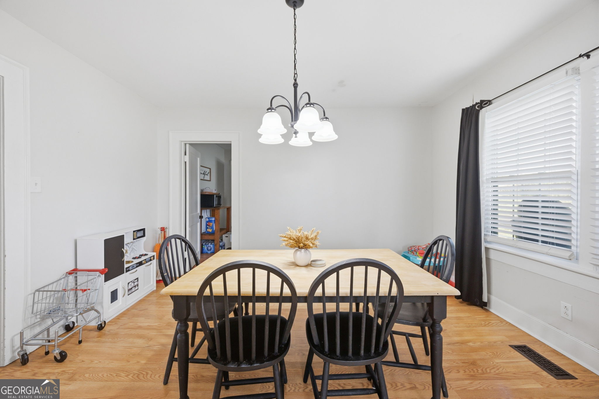 176 Childs Street Gray, GA 31032 - Photo 5 of 22 a dining room with furniture a chandelier and wooden floor