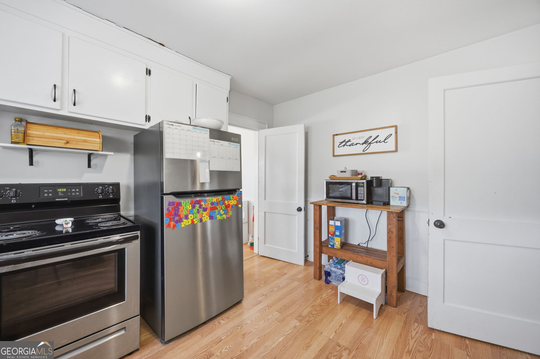 176 Childs Street Gray, GA 31032 - Photo 9 of 22 a kitchen with stainless steel appliances a stove and wooden floor