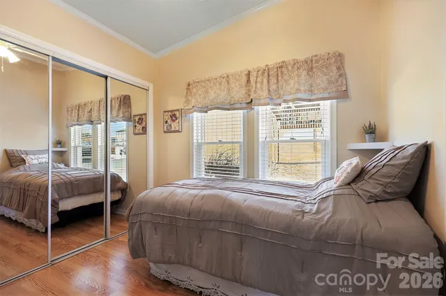 a bedroom with a bed and a large window