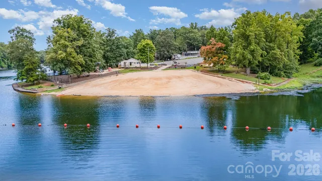 an aerial view of a house with swimming pool garden and patio