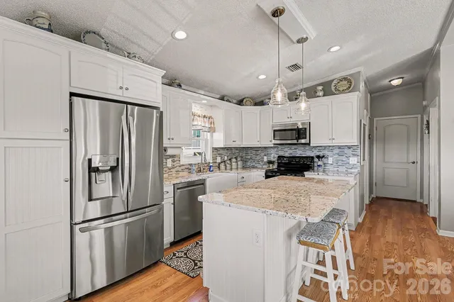 a kitchen with stainless steel appliances a refrigerator sink and microwave
