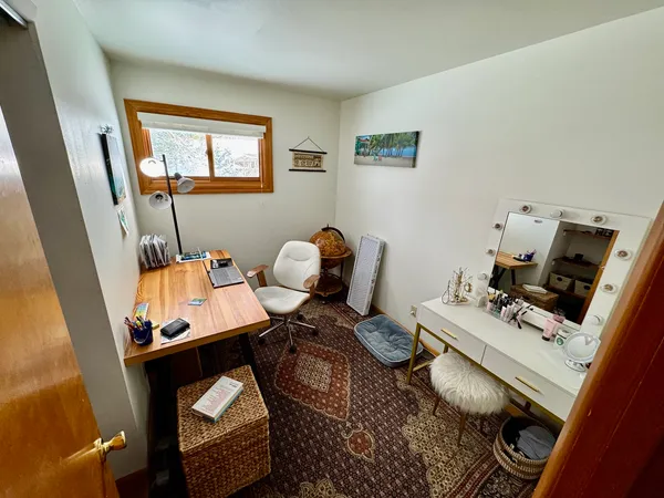 a workspace with furniture and a window