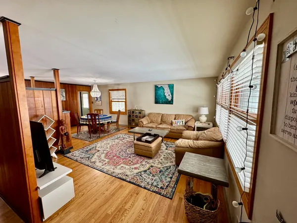a living room with furniture large window and a flat screen tv
