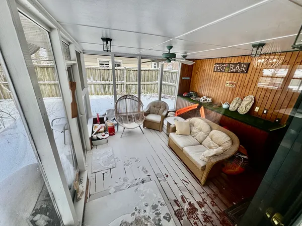 a living room with furniture and a floor to ceiling window
