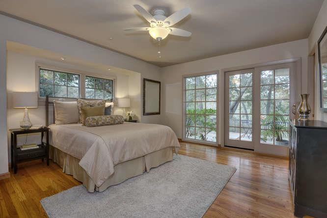 18531 Decatur Road Los Gatos, CA 95030 - Photo 12 of 23 a bedroom with a large bed and a large window with wooden floor