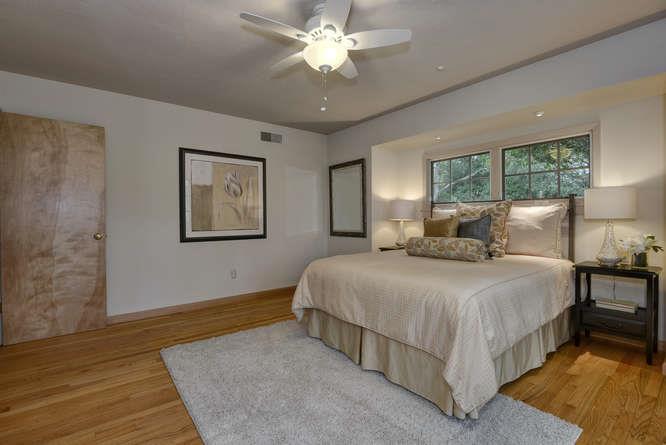 18531 Decatur Road Los Gatos, CA 95030 - Photo 13 of 23 a bedroom with a bed and a chandelier