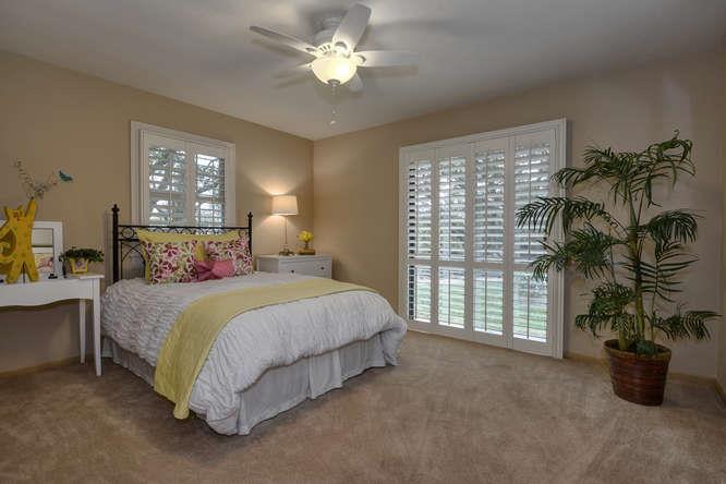 18531 Decatur Road Los Gatos, CA 95030 - Photo 17 of 23 a bedroom with a bed and a chandelier