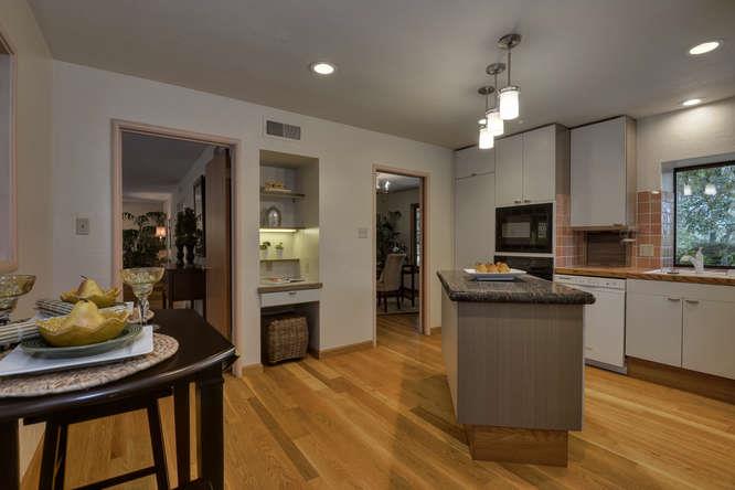 18531 Decatur Road Los Gatos, CA 95030 - Photo 7 of 23 a kitchen with stainless steel appliances kitchen island granite countertop a table chairs in it and wooden floors