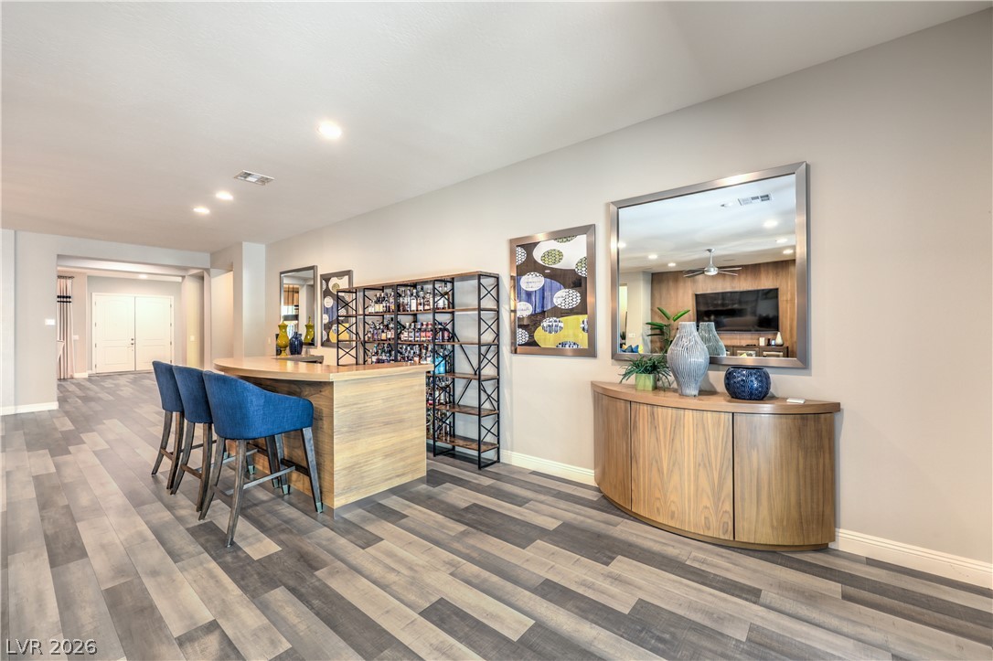 7119 Arabian Ridge Street Las Vegas, NV 89131 - Photo 23 of 73 A well-appointed recreation area features a stylish bar and contemporary flooring.