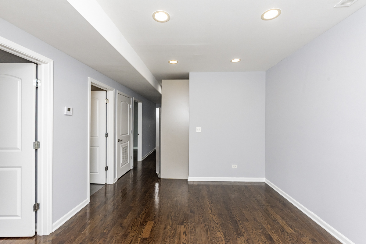1012 South 1st Avenue, Unit 103 Maywood, IL 60153 - Photo 3 of 13 a view of a hallway with wooden floor