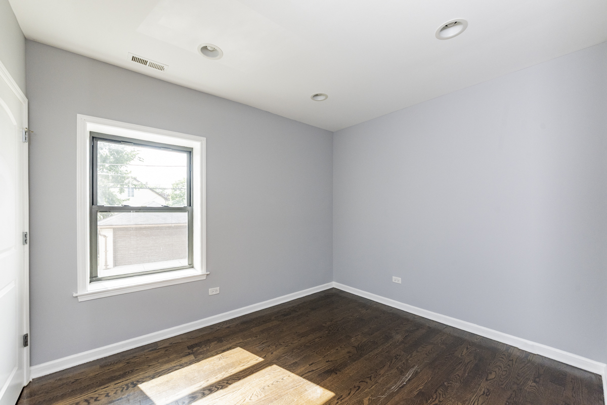1012 South 1st Avenue, Unit 103 Maywood, IL 60153 - Photo 4 of 13 an empty room with a window