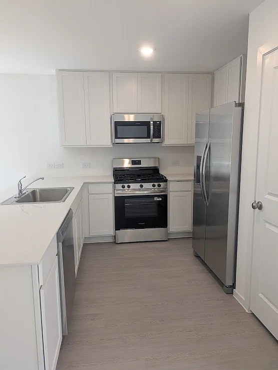 9015 Rose Pelican Lane Baytown, TX 77521 - Photo 11 of 14 a kitchen with stainless steel appliances granite countertop a refrigerator sink and stove