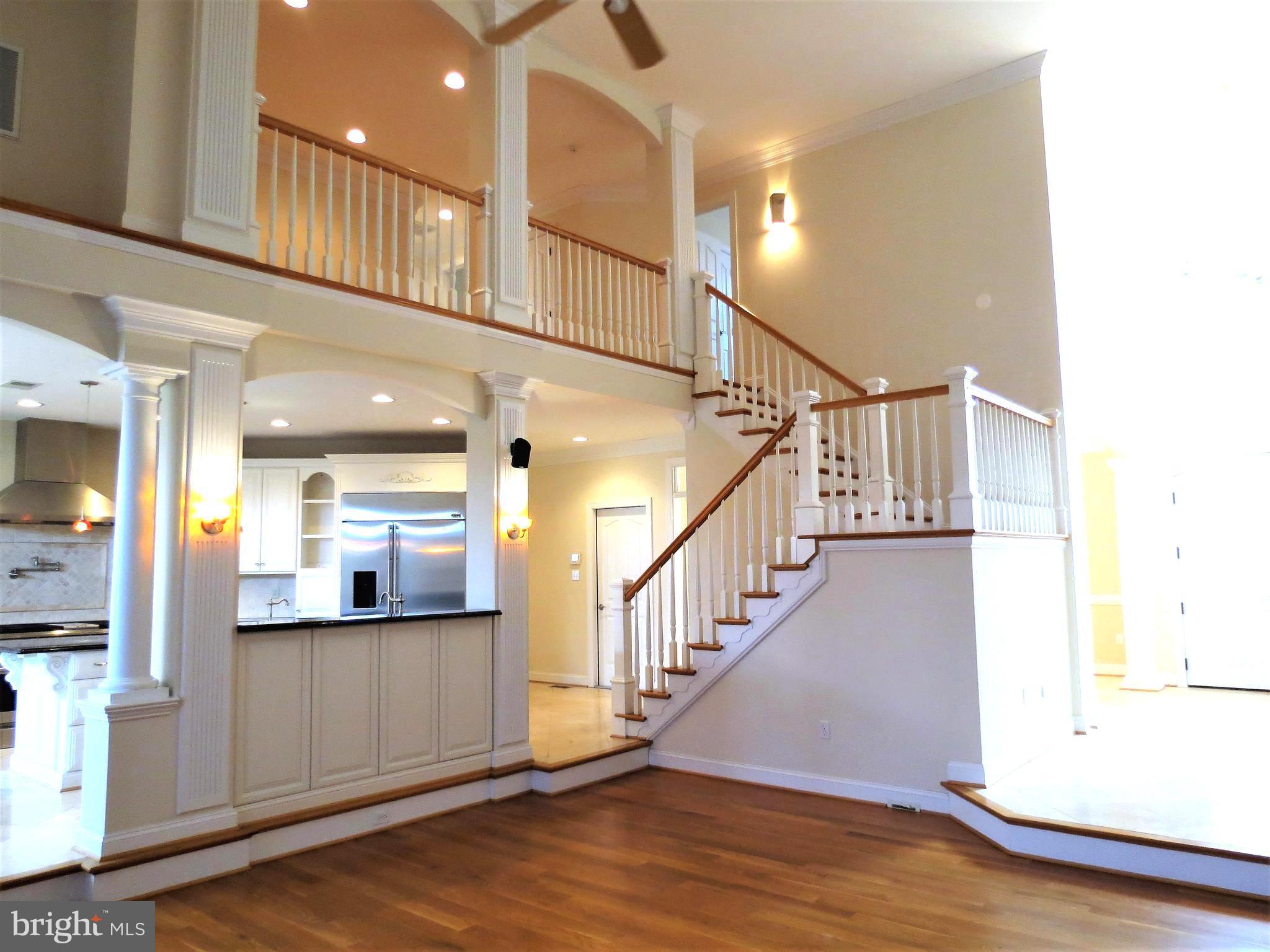 6170 Scaggs Road Owings, MD 20736 - Photo 12 of 30 a view of staircase and kitchen with a large window