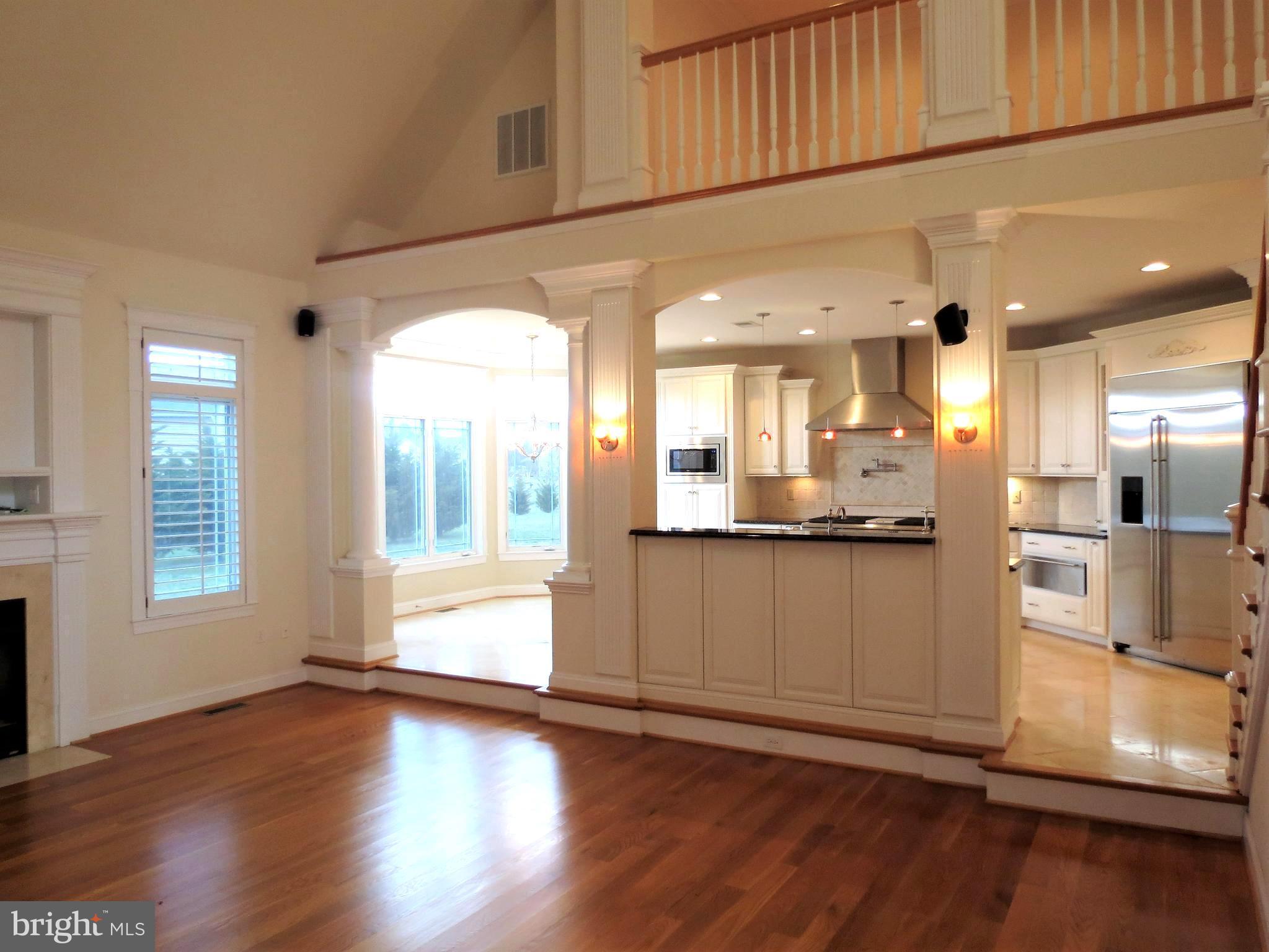 6170 Scaggs Road Owings, MD 20736 - Photo 14 of 30 a view of a large kitchen with a large window wooden floor and a kitchen