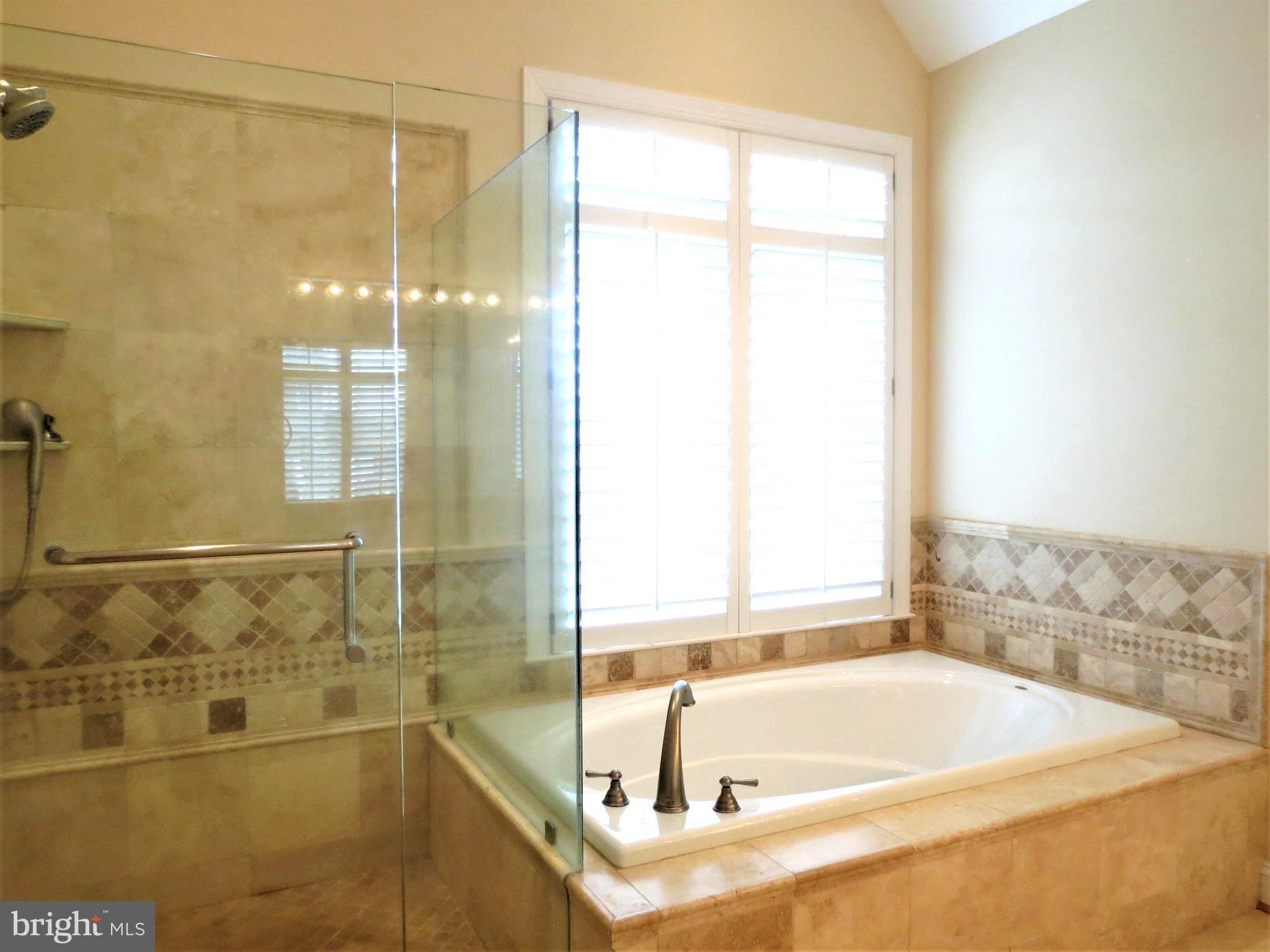 6170 Scaggs Road Owings, MD 20736 - Photo 15 of 30 a bathroom with a tub and a shower