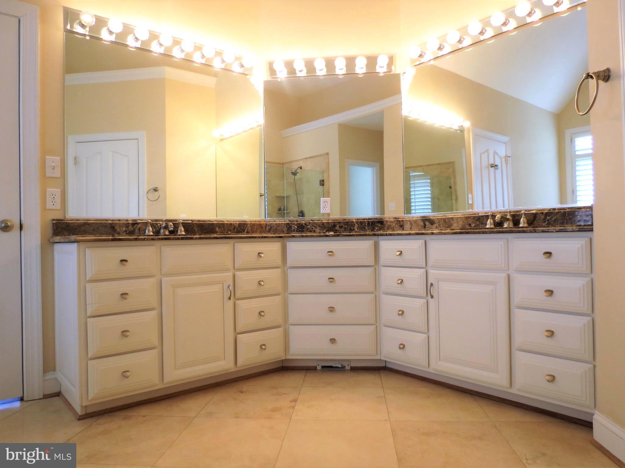 6170 Scaggs Road Owings, MD 20736 - Photo 19 of 30 a spacious bathroom with a granite countertop sink and a mirror