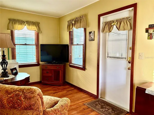 a bedroom with furniture and a flat screen tv