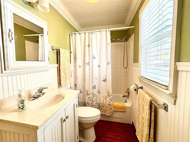 a bathroom with a sink a toilet and a window