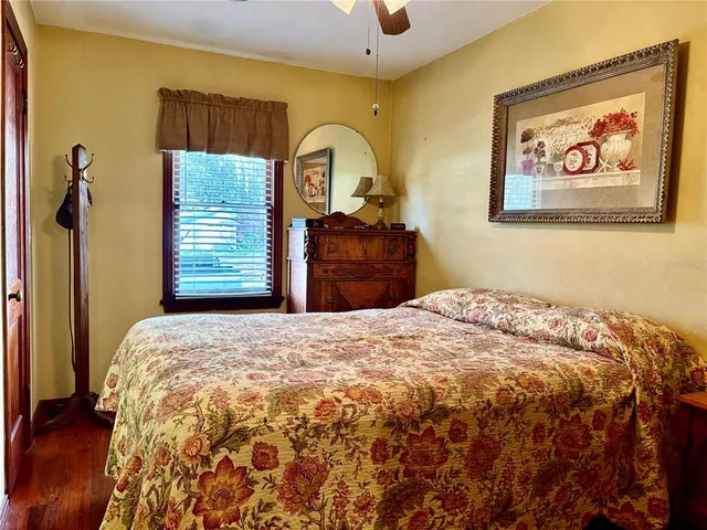 a bedroom with a bed and a painting on the wall