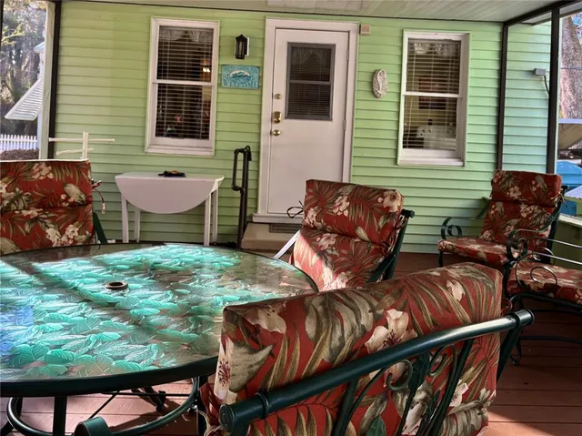 a view of a chairs and table in the balcony