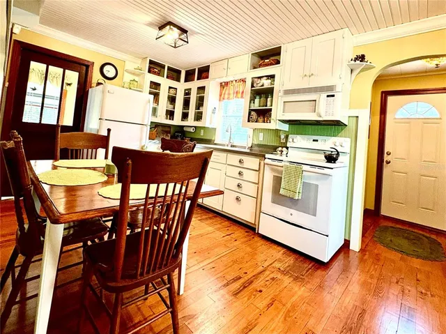a living room with stainless steel appliances kitchen island granite countertop furniture and a dining table
