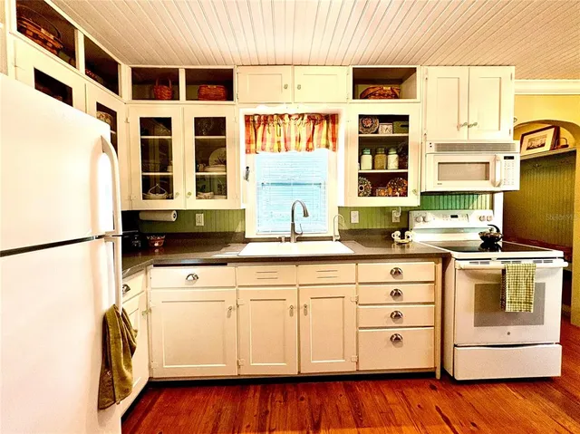 a kitchen with stainless steel appliances a stove a sink and a refrigerator