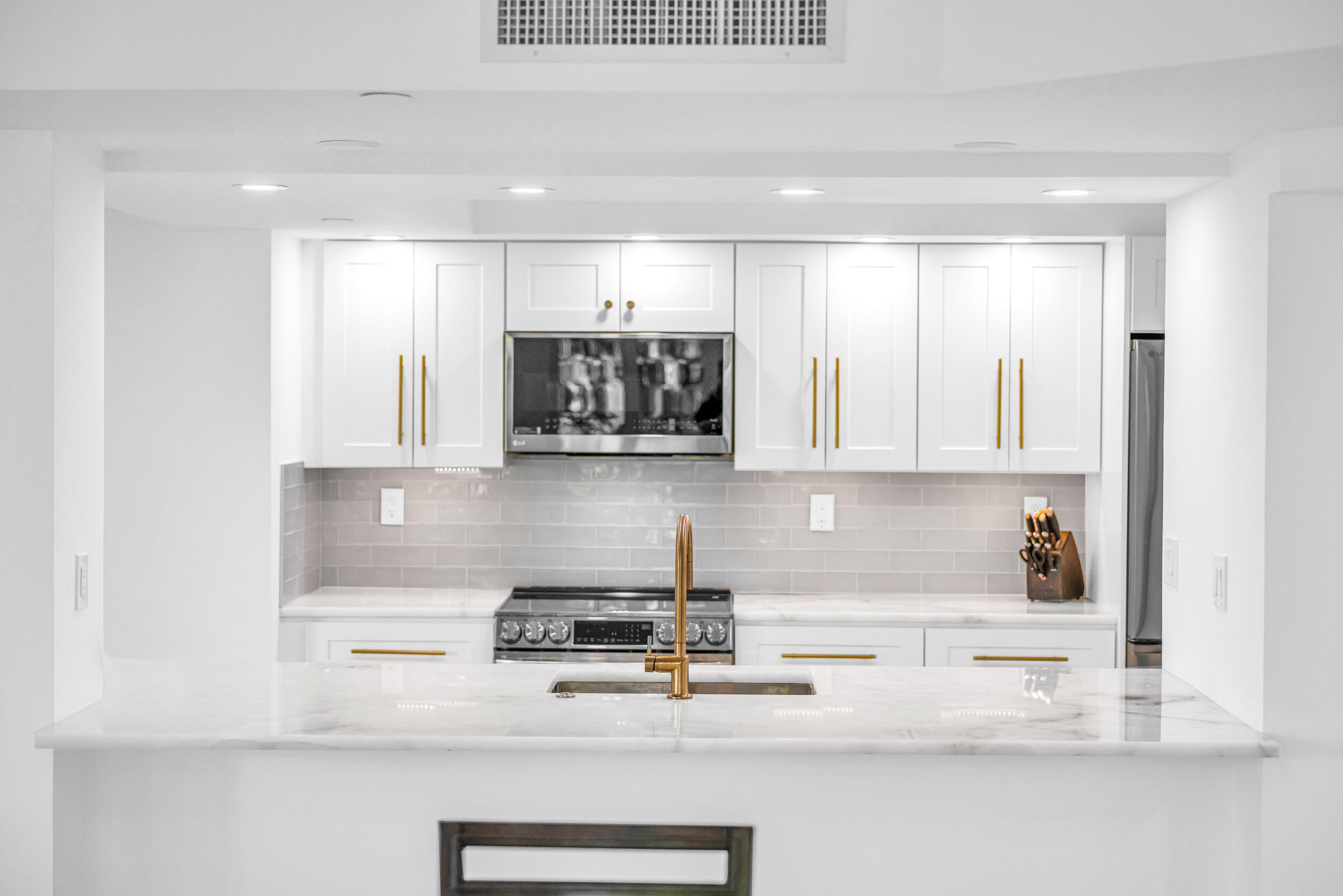 100 Southeast 5th Avenue, Unit 304 Boca Raton, FL 33432 - Photo 13 of 62 a kitchen with a white cabinets and window