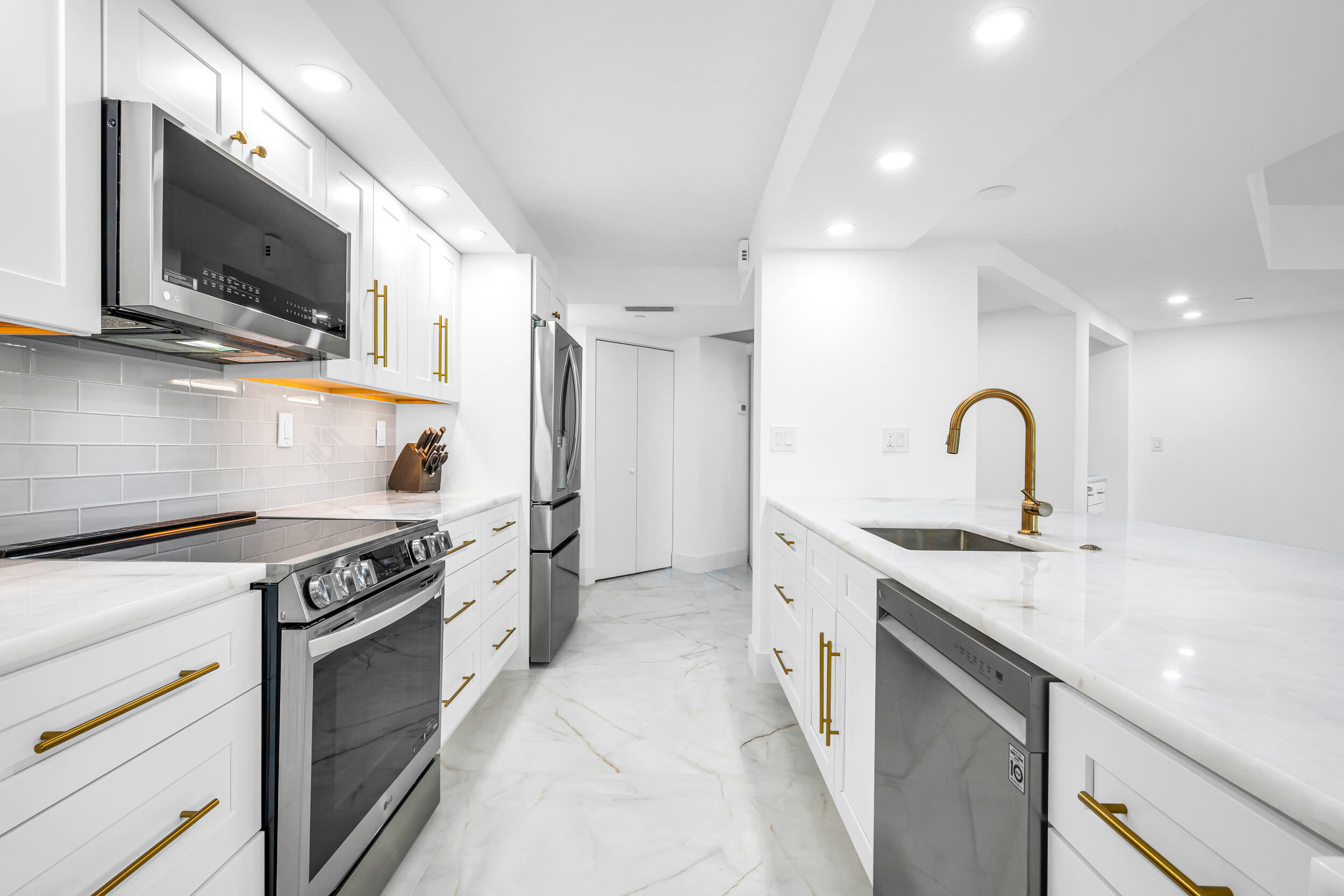100 Southeast 5th Avenue, Unit 304 Boca Raton, FL 33432 - Photo 22 of 62 a kitchen with a sink stove and microwave