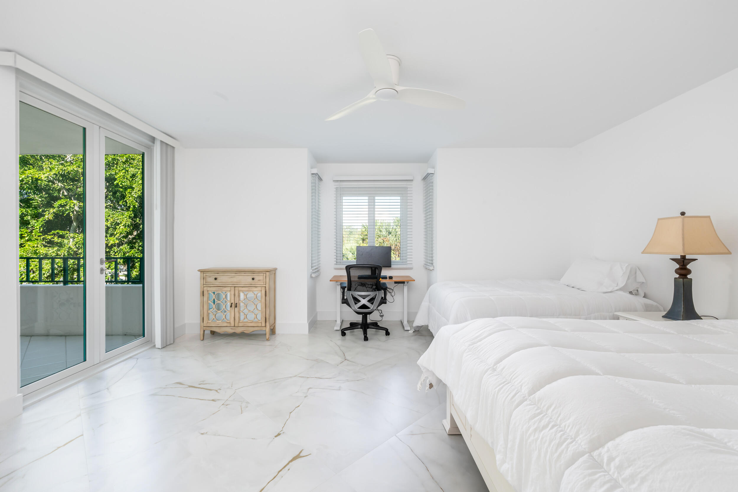 100 Southeast 5th Avenue, Unit 304 Boca Raton, FL 33432 - Photo 6 of 62 a bedroom with a bed and a chandelier