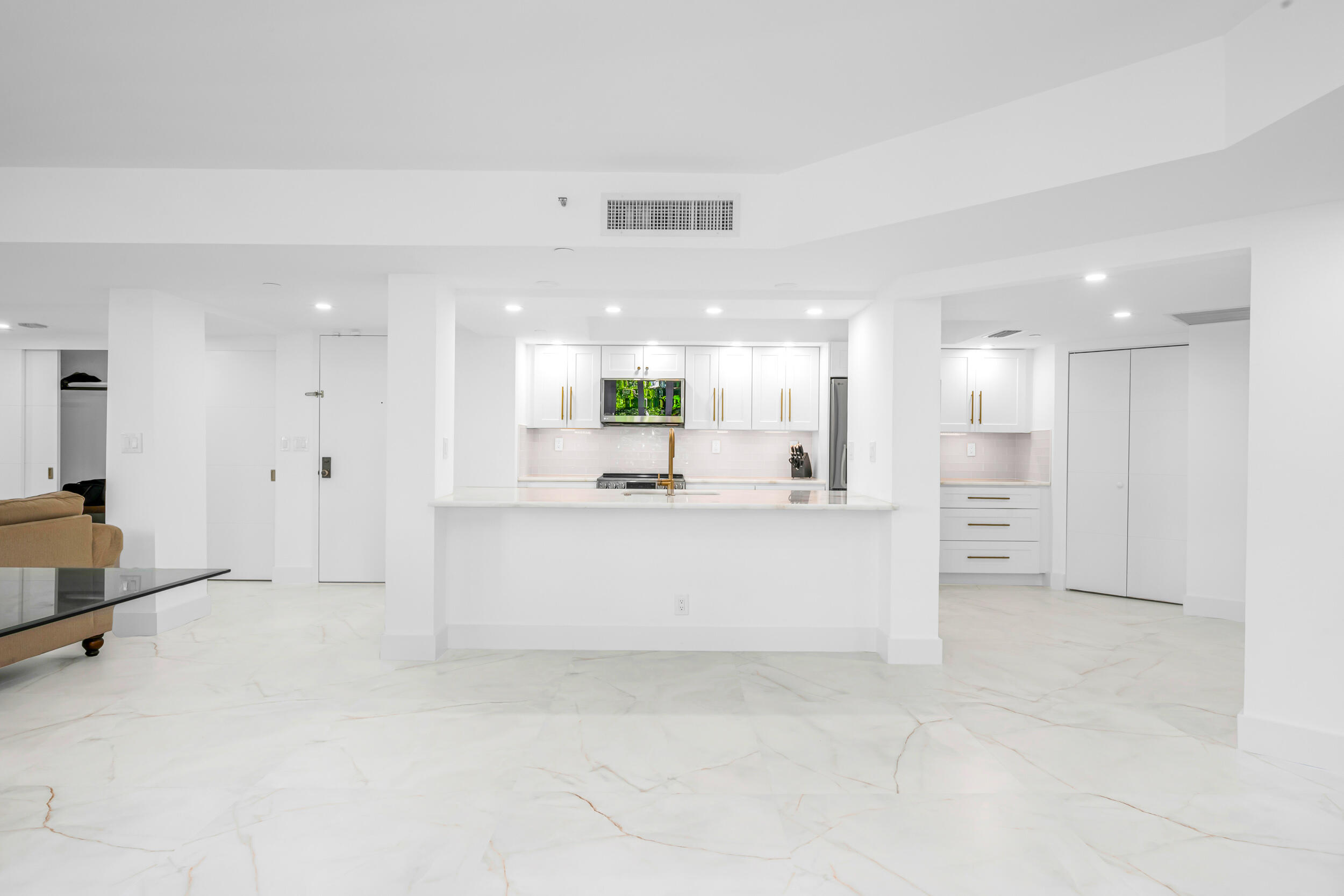 100 Southeast 5th Avenue, Unit 304 Boca Raton, FL 33432 - Photo 8 of 62 a view of kitchen with white cabinets stainless steel appliances with white walls