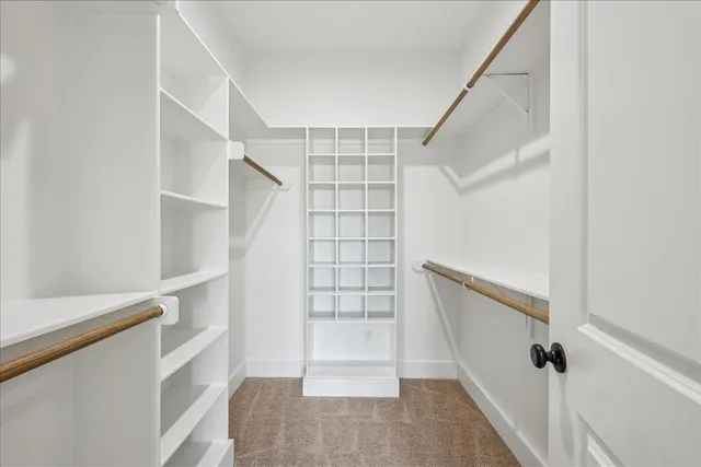 a view of walk in closet with empty racks