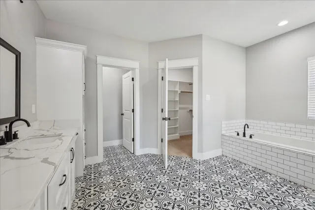 a bathroom with a sink a mirror and a bathtub