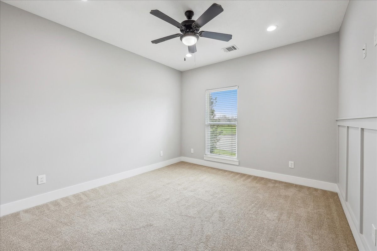 7722 Pond Circle Beaumont, TX 77707 - Photo 21 of 34 an empty room with a window and a ceiling fan