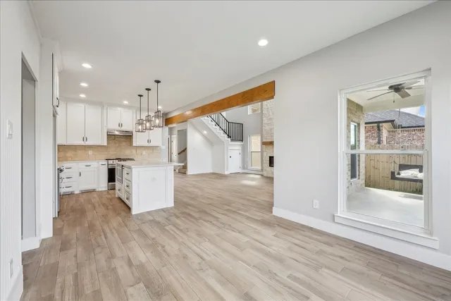 a view of kitchen with wooden floor and electronic appliances