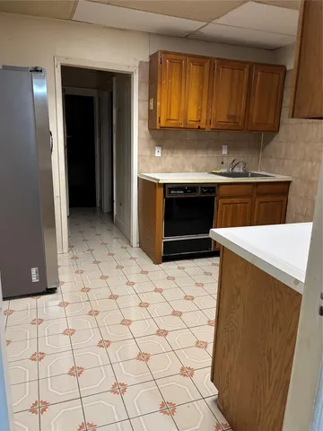 a kitchen with granite countertop a stove a sink and a microwave