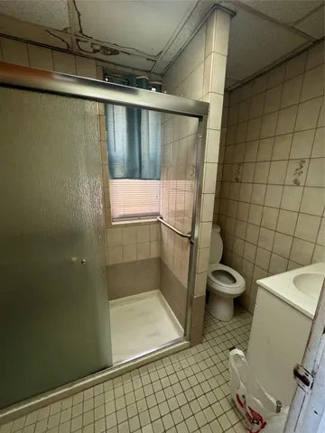 a bathroom with a shower and a toilet