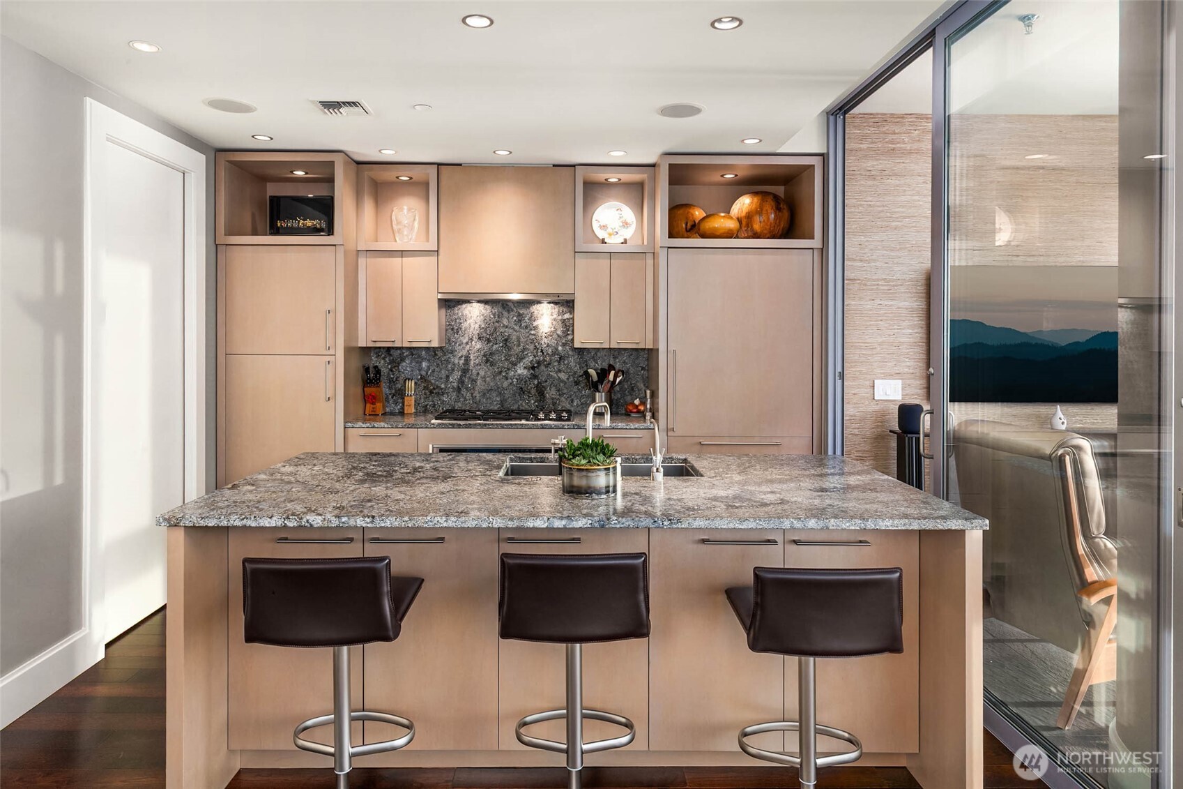 1521 2nd Avenue, Unit 2800 Seattle, WA 98101 - Photo 13 of 35 a view of kitchen with stainless steel appliances kitchen island granite countertop dining table chairs cabinets and a sink